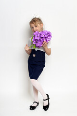 little girl posing with purple lilac flower