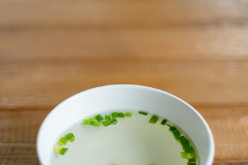 Small bowl of clear soup and vegetable