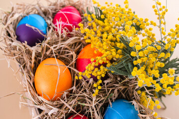 Easter eggs. Festive decoration. Easter. Celebration. Bright holiday. Eggs on a beige background. Multi-colored eggs on a beige background.