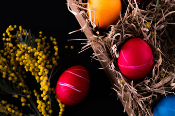 Fototapeta na wymiar Easter eggs. Festive decoration. Easter. Celebration. Bright holiday. Eggs on a black background. Multi-colored eggs on a black background.