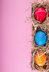 Easter eggs. Festive decoration. Easter. Celebration. Bright holiday. Eggs on a pink background. Multi-colored eggs on a pink background.