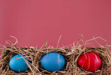 Easter eggs. Festive decoration. Easter. Celebration. Bright holiday. Eggs on a red background. Multi-colored eggs on a red background.