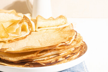 Yeast flour pancakes on a light background