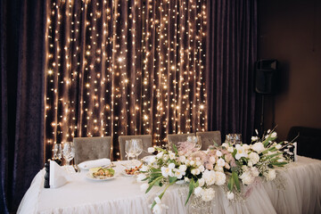 Wedding table for brides in a restaurant decorated with flowers