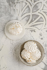 Fototapeta na wymiar meringue cakes on a concrete background