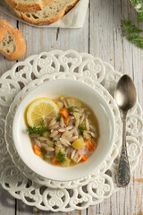 Vegetable soup. White rustic food photography, cottage styling