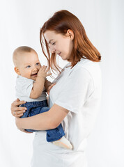 mother with a child in white t-shirts and blue jeans. White background