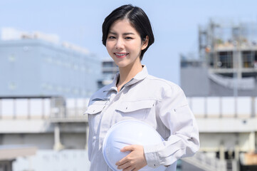 Smiling Asian woman in work clothes