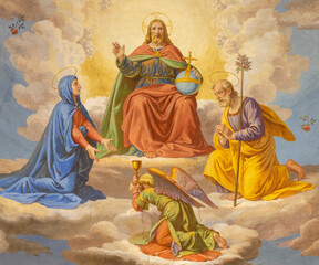 ROME, ITALY - AUGUST 29, 2021: The detail of fresco of Jesus the Pantokrator with the Virgin Mary and St. Joseph in the church Chiesa di Santa Maria della Scala by unknown artist. © Renáta Sedmáková