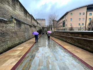 Heavy rain, with homeward bound shoppers, in the post industrial city of, Bradford, Yorkshire, UK