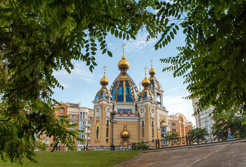 Fototapeta na wymiar Orthodox church surrounded by acacia branches. Kyiv, Ukraine