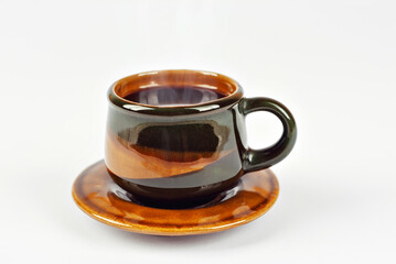 Ceramic brown coffee mug close up. Coffee isolated on a white background. Copy space and free space for text near the drink.