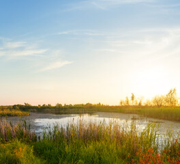 small quiet lake among prairie at the sunset