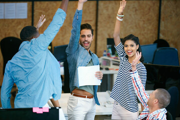 Shout out to the best team ever. Shot of a team of colleagues celebrating in a modern office.