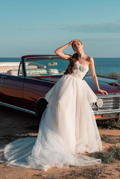 Fashion bride model in luxury wedding dress on seashore