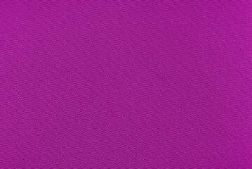 The background is made of purple material. Fabric for sewing clothes in a dark shade. Texture