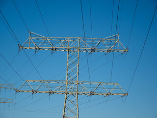 High voltage wires. Energy supply. Metal poles of electrical wires.