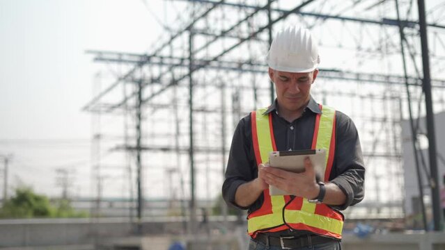 senior construction worker or architect using digital tablet checking structure in construction site outdoors Hand shading with Hot weather and sunny. builders in hard hat inspecting and working