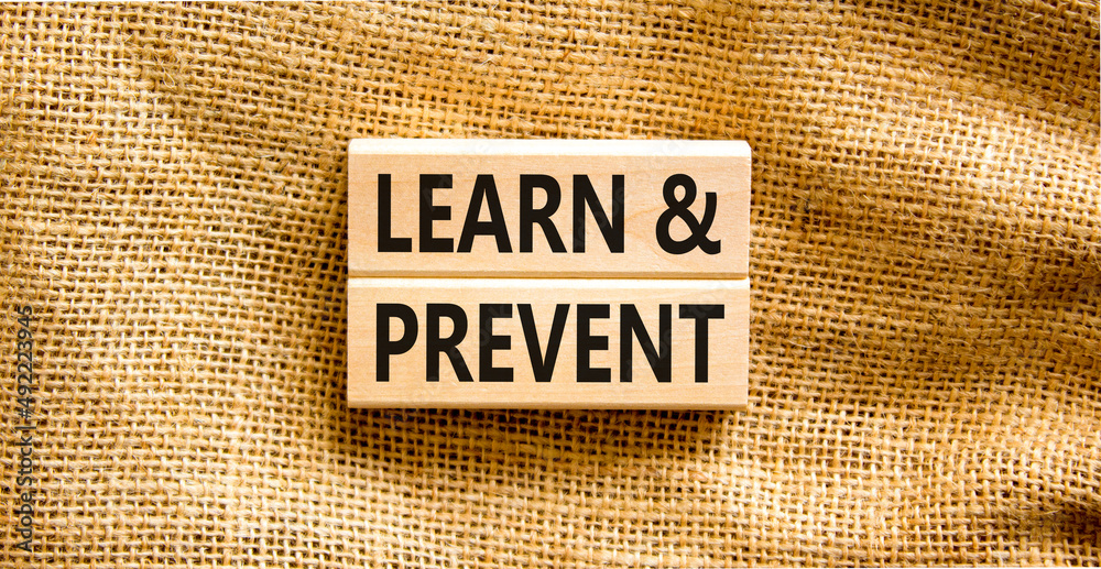 Poster Learn and prevent symbol. Concept words Learn and prevent on wooden blocks on a beautiful canvas table canvas background. Business learning and learn and prevent concept, copy space.