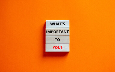 What is important to you symbol. Concept words What is important to you on wooden blocks. Beautiful orange table orange background. What is important to you business concept. Copy space.