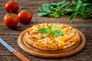 Pizza with bacon and mozzarella cheese on wooden plate