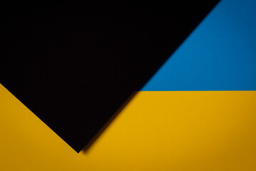 Abstract color papers geometry flat lay composition background with blue, yellow, black tones