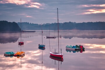 Beautiful morning landscape. Boats on the lake in the morning.