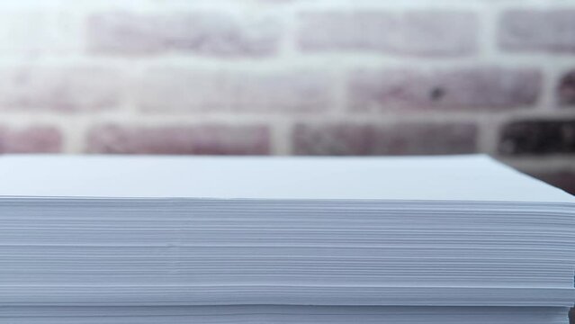 close up of stack of empty paper on table 