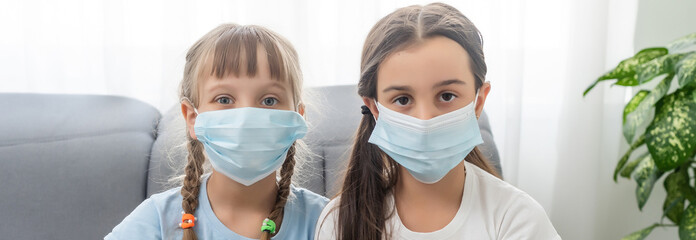 Two little kid girls in sterile face mask. Epidemic pandemic coronavirus 2019-ncov sars covid-19...