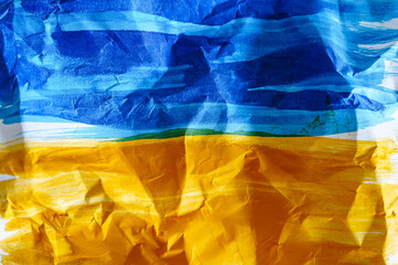 Ukraine colors at the folded white paper
