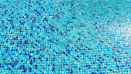Swimming pool surface top view caustics ripple and flow with waves background, Swimming pool for background. Texture of water surface.