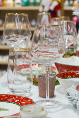 Christmas table decor, glasses, cookies on a tray, plates with a Christmas theme, christmas market