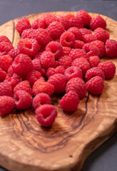 Fresh and tasty looking raspberries on a wooden table