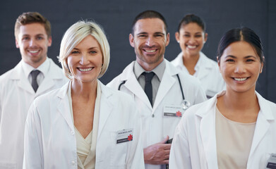 Medicines finest. Studio portrait of a team of doctors standing against a grey background.