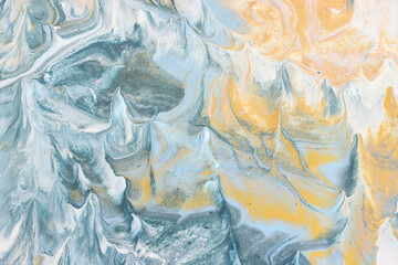 art photography of abstract marbleized effect background with gold, blue and gray creative colors. Beautiful paint.