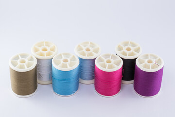 Colorful sewing thread spool isolated on white background