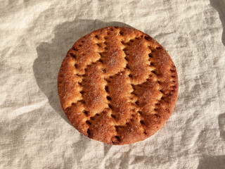 Close-up to cinnamon crispbread on textile background, Swedish traditional crispbread baked with wheat.