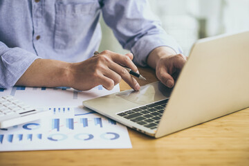 Businessman working laptop for new architectural project. Generic design notebook on the table....