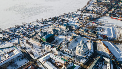 The ancient monastery behind the fortress wall. Beautiful churches with domes. Old Russian architecture. Winter day.