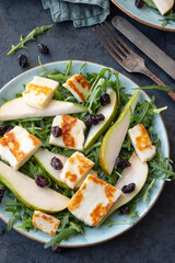 Salad with Halloumi cheese, pear, arugula, and cranberry