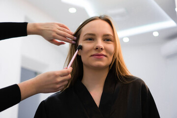 Portrait of beautiful woman getting cosmetic care at beauty salon