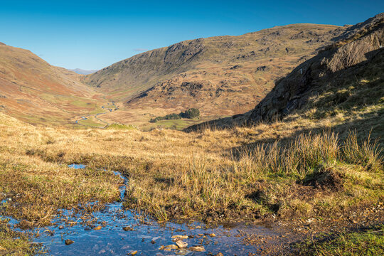 A Sunny, Winter HDR Landscape Image Of Wrynose Bottom From The Top Of Hardknott Pass With A Distant Helvellyn, Cumbria, England