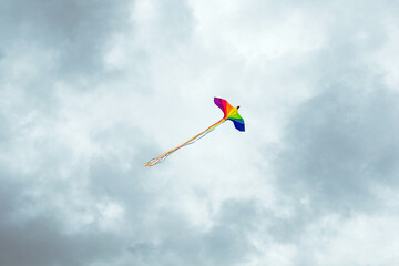 A beautiful and bright rainbow flag flies despite the gloomy impending storm.