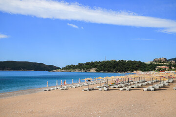 Fototapeta na wymiar Beautiful beach with sunshades in Montenegro