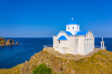 Fototapeta na wymiar The small church of Agios Nikolaos at the entrance of the port of Myrina on the island of Lemnos in Greece