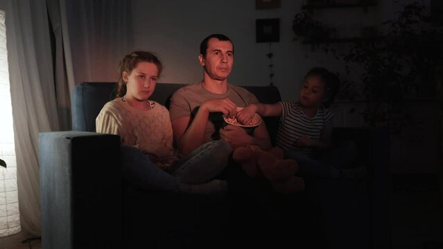 stay home. family - dad, daughter and small child are watching coronavirus tv. quarantine happy family together concept. happy family watching tv together. kid dream. people watching online movies