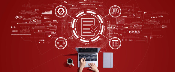 Compliance concept with person working with a laptop