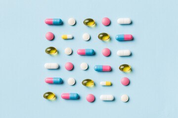 Many different pills and space for text on colorful background, top view. Different pills on color background, flat lay
