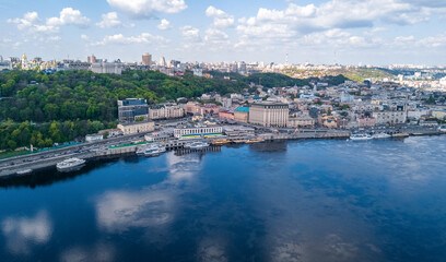 Fototapeta na wymiar Kyiv cityscape aerial drone view, Dnipro river, downtown and Podol historical district skyline from above, city of Kiev and Dnieper, Ukraine