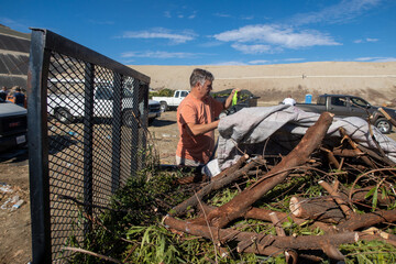 A Man at the Dump Sanitary Landfill Unloading a Load of Residential Yard Waste